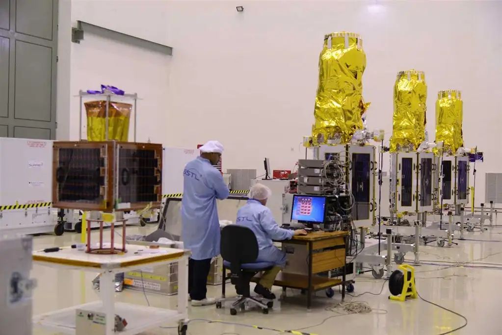 Image of CBNT-1 (left) and three DMC3 Satellites (right) in the cleanroom at SDSC SHAR