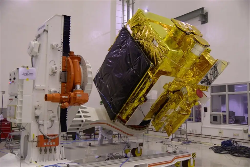 A TILTED VIEW OF ASTROSAT WITH FOLDED SOLAR ARRAYS WRAPPED IN A PROTECTIVE COVERING